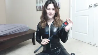 Erin Marie O'Keefe aka Goddess Green Eyed cbt-riding-crop-in-catsuit